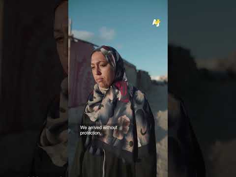 Displaced Palestinian Mother Walking Across Gaza